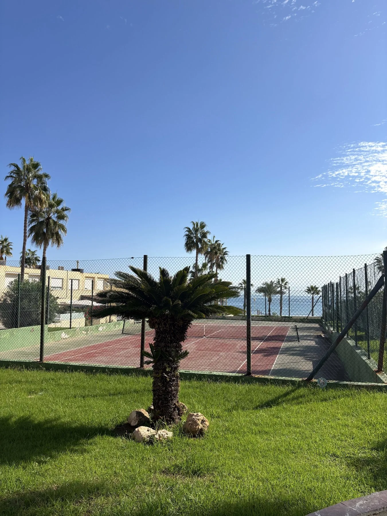 Community grounds with sports court and sea views